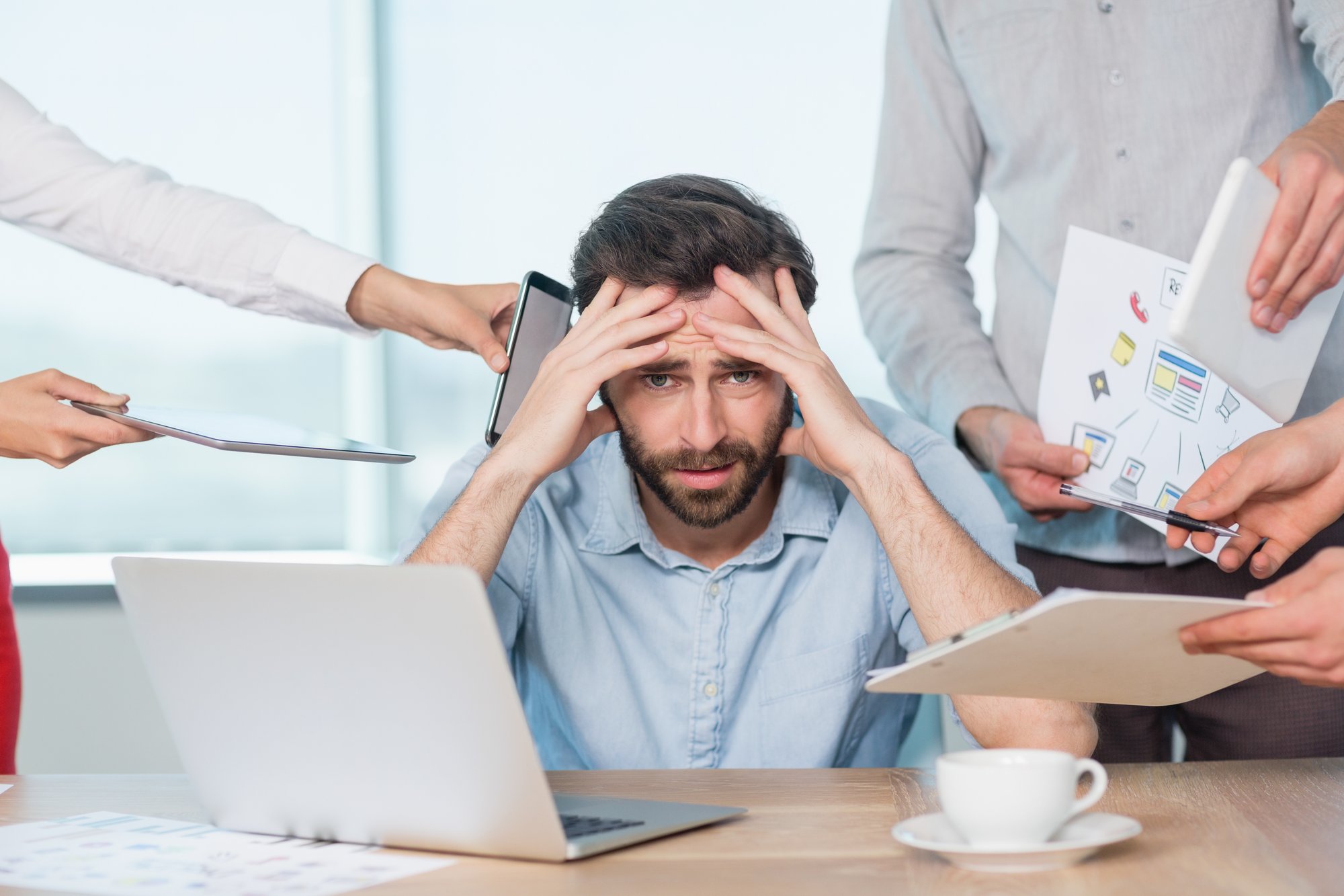 colleagues-with-document-digital-tablet-mobile-phone-talking-frustrated-man